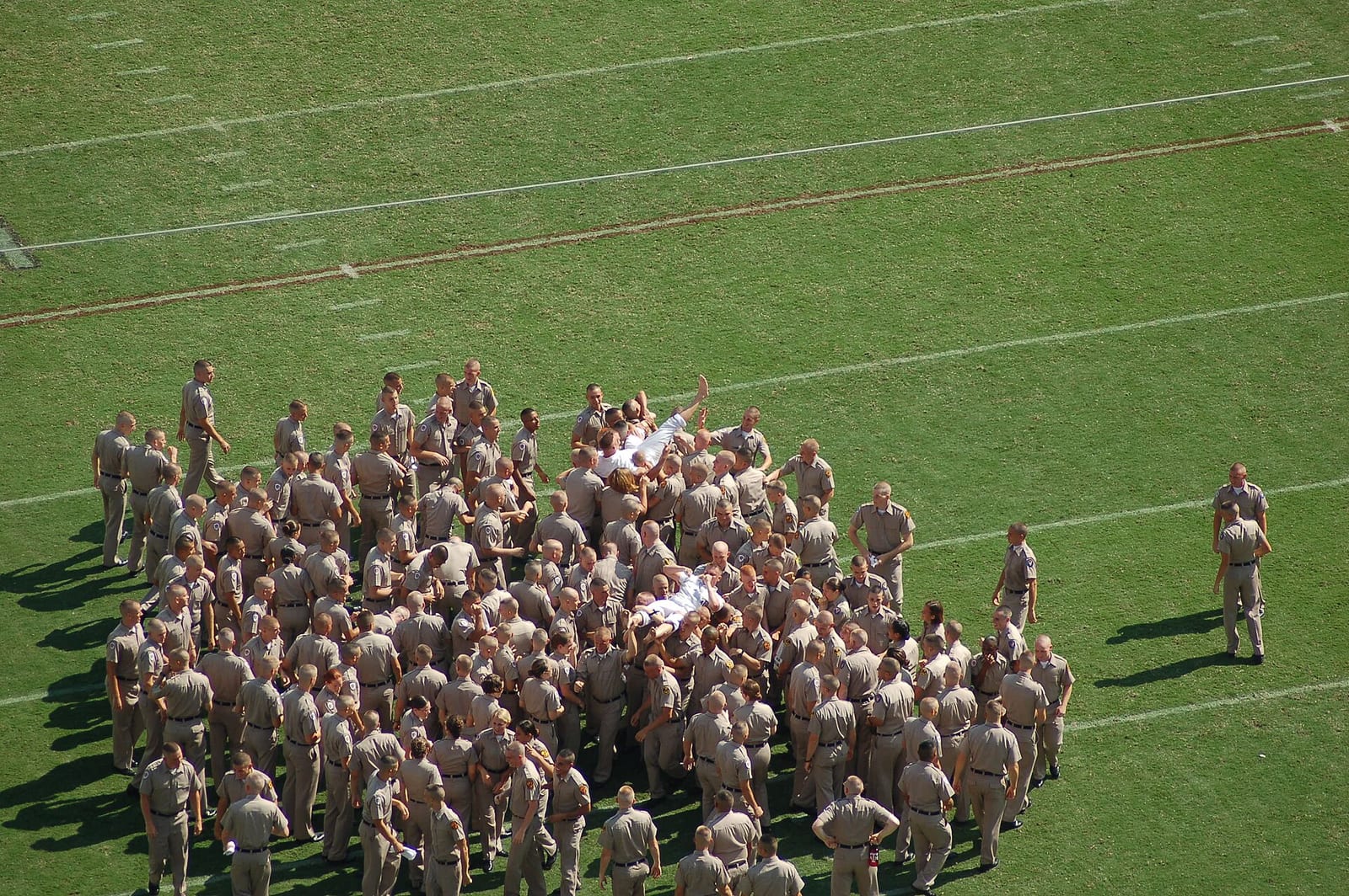 A crowd of cadets gathered on the field