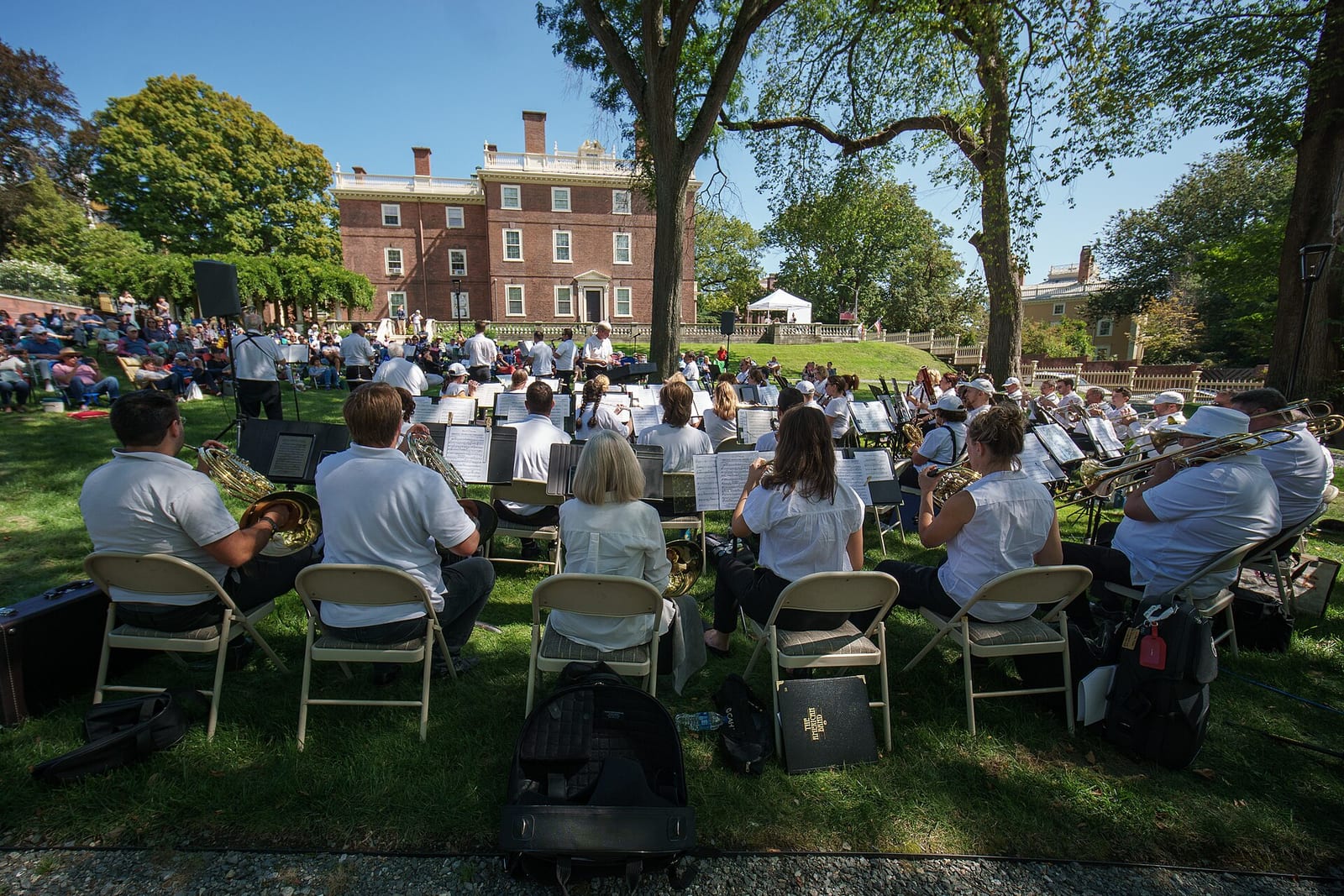 An audience on folding chairs at an outdoor concert